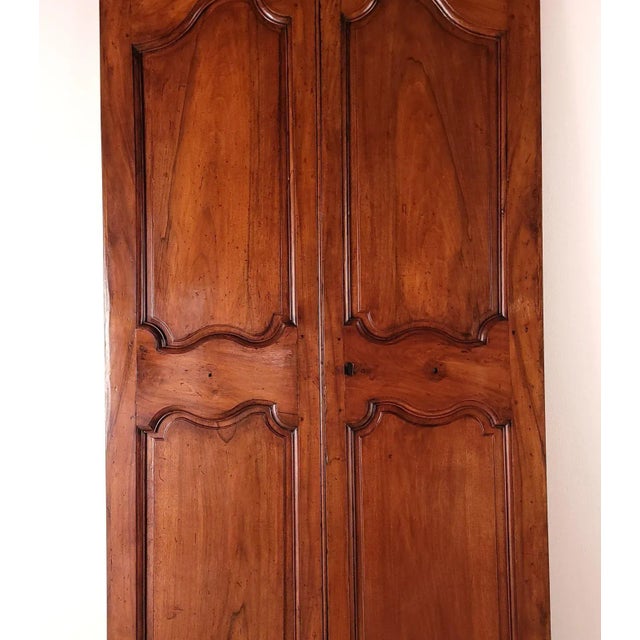 A pair of walnut doors, France, 19th century or earlier. Some old repairs. Impressive & sophisticated.