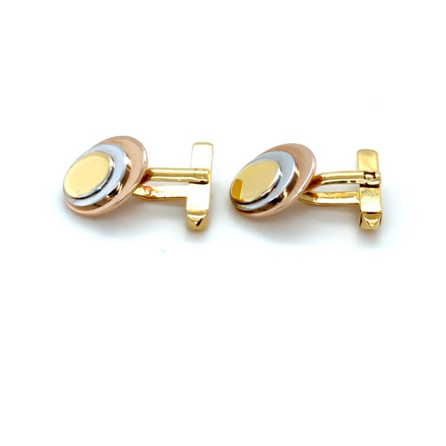 These stylish cufflinks by Bulgari depict a circular design with a mixture of gold colors including a rose gold disk,...