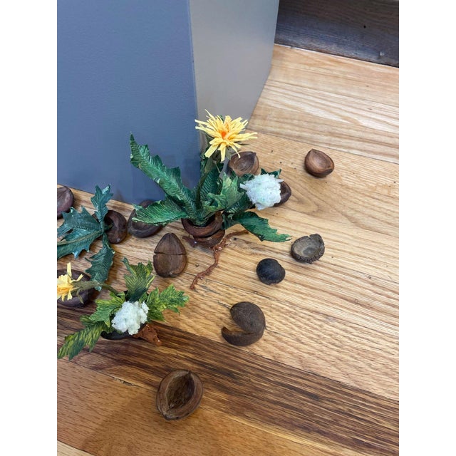 Broken Dreams by Ashley Folkner | Mixed Media Arrangement of flowers and nuts on a wooden surface For Sale