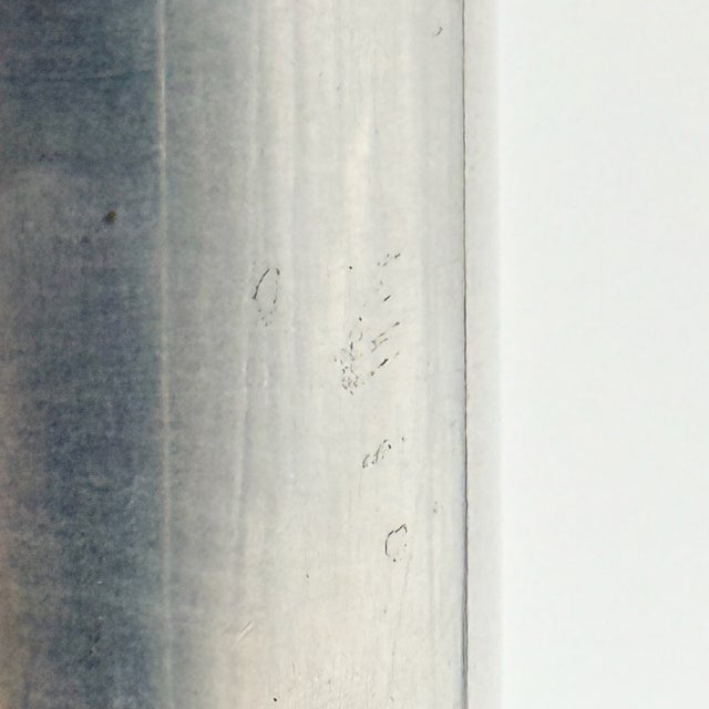 A cylindrical metal vase produced by Atelier des Orfèvres in Italy during the 1970s. The piece is distinguished by an...