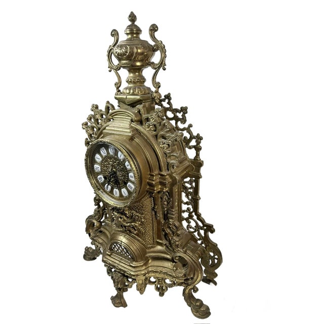 Add some French elegance to your decor with this beautiful and ornate Franz Hermle brass mantel clock with matching...
