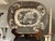 A wonderfully atmospheric mid-19th-century English black transfer-printed earthenware platter featuring an elaborate...