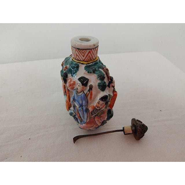 19th C. Chinese Molded Famille Rose Porcelain Snuff Bottle with Stand A masterful example of late Qing Dynasty...