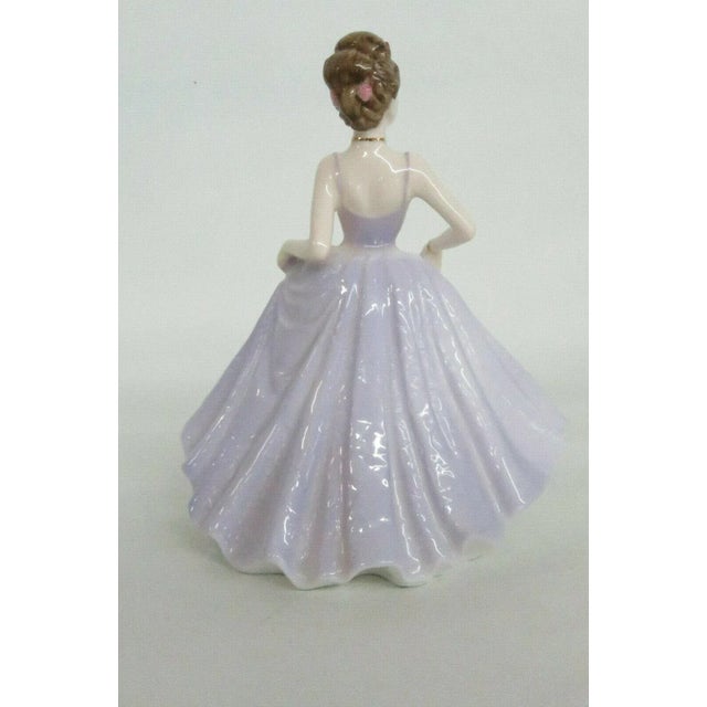 This gorgeous figurine is made of bone china / porcelain. This classic figurine is stamped as being made by Coalport, the...