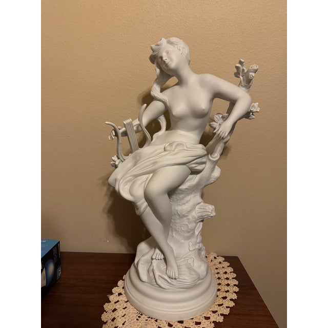 triking large-scale French bisque porcelain sculpture depicting a graceful seated female muse holding a mandolin. The...