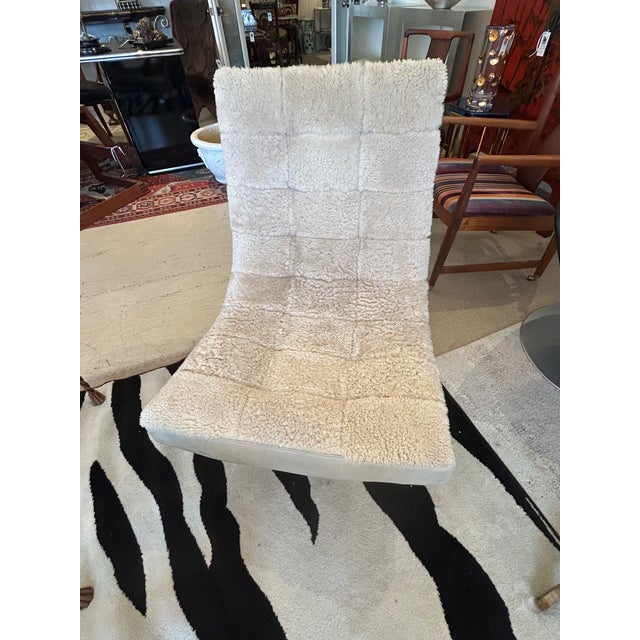 Sexy cream leather and sheepskin upholstered sling shaped chair on a chrome base has movie star looks. Details Creator...