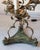 Elegant pair of 20th century Italian wrought iron three-light candelabra table lamps featuring a warm mecca silver-leaf...