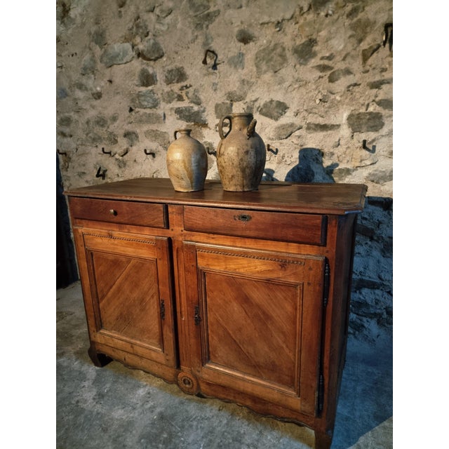 Elegant antique sideboard from France, dating to around 1850. This beautifully crafted piece combines mahogany, oak, and...