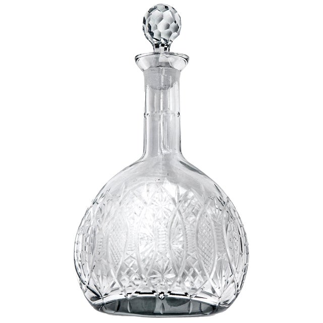 An unusual set of crystal decanters, one round & the other oval. The small round decanter has been re-marked by the...