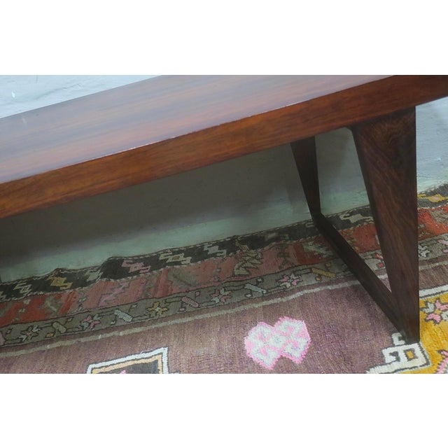 Unusual Danish rosewood coffee table, the top curved on one side, standing on sled feet.