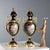 A pair of blue porcelain and gilt bronze vases. Decorated in pure gold with plant motifs and a floral arrangement on the...