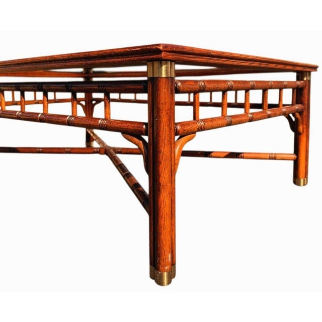 Elevate your living space with the timeless elegance of the Ralph Lauren Faux Bamboo Walnut Coffee Table. Masterfully...