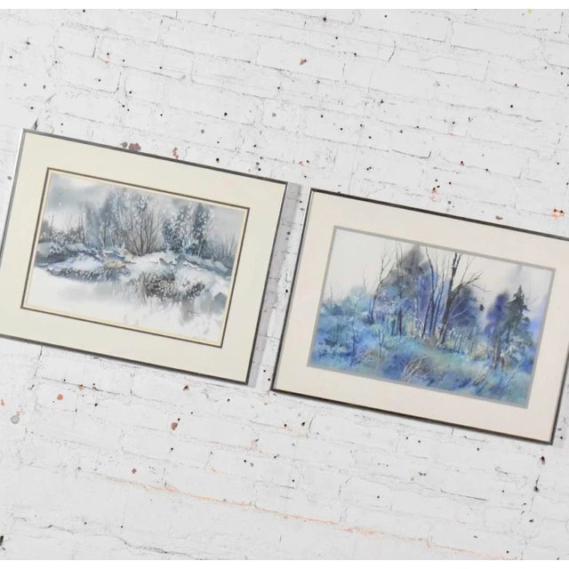 Handsome pair of watercolor paintings each depicting a different winter landscape by Dorothy M. Reece Kordash. They are in...