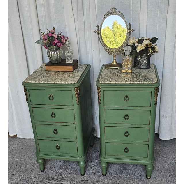Vintage pair of French Louis XVI style marble-top nightstands , semainiers, chiffoniers or bedside tables. They feature a...