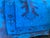 A tall totemic emblem rises from an oval base at the center of the piece, its branch-like tiers stepping outward in deep...