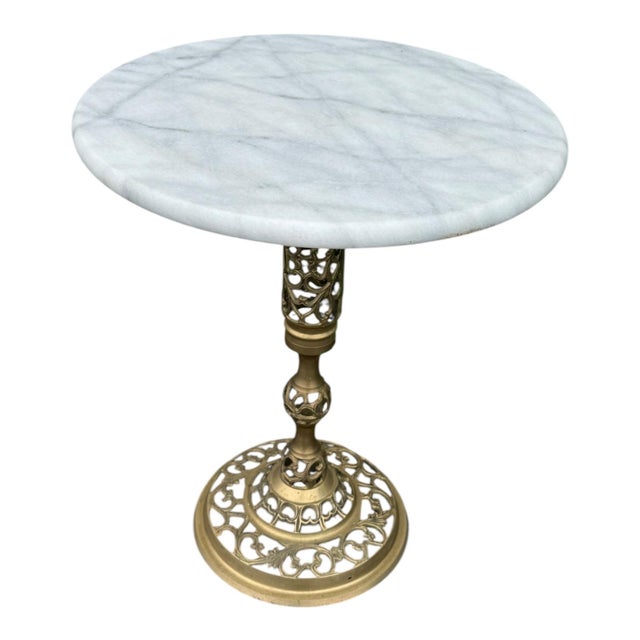 Vintage round accent table featuring a blue marble top and ornate brass-tone pedestal base. Elegant Hollywood Regency-...