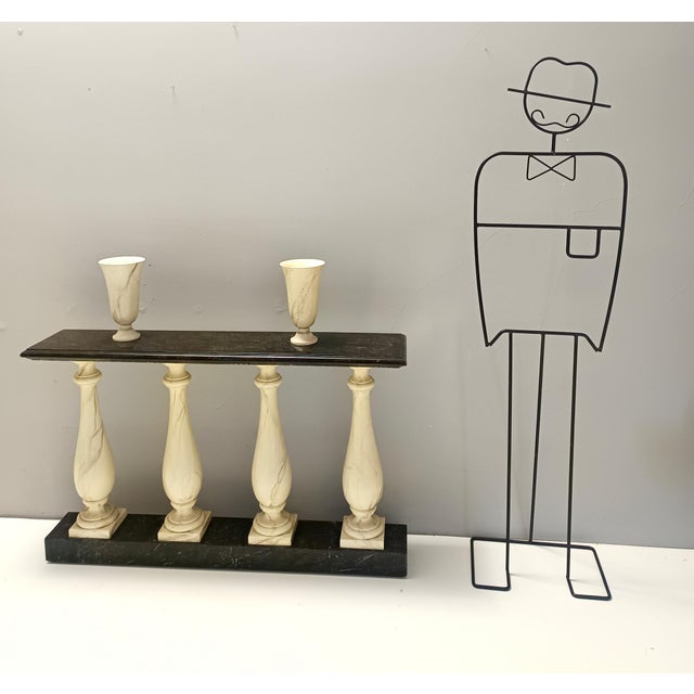 Made in Italy, 1960s. This console table features an ivory and black painted beech frame and top. It has a natural looking...