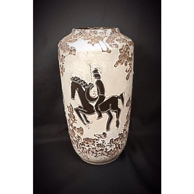Add a touch of vintage elegance to your collection with this grand vase from West Kéramik, featuring a charming knight...