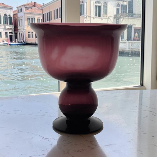 This hand-blown amethyst art glass pedestal compote or centerpiece was probably produced in the United States during the...