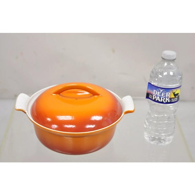 Vintage Descoware Mid Century Modern Cast Iron Orange Enamel Lidded Dutch Oven. Circa Late 20th Century. Measurements: 5"...