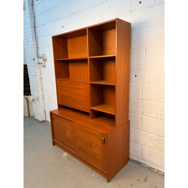 A mid-century modern Danish stackable bookcase crafted in warm teak by Domino Møbler of Denmark. This versatile piece...