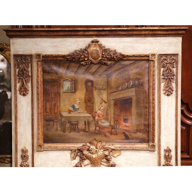 This elegant, carved antique trumeau was crafted in France, circa 1880. The hand painted canvas depicts an interior scene...
