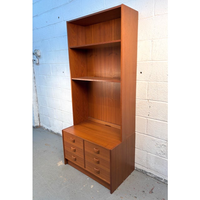 A classic mid-century modern Danish stackable bookcase crafted in warm, beautifully grained teak by Domino Møbler of...