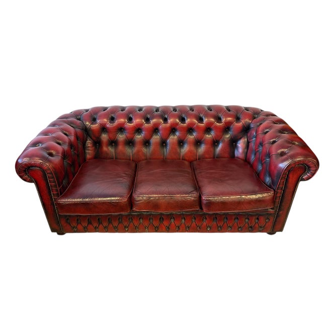 Genuine three seat sofa with deep button tufting. Traditional Chesterfield with rolled arms and studded detailing Thick,...