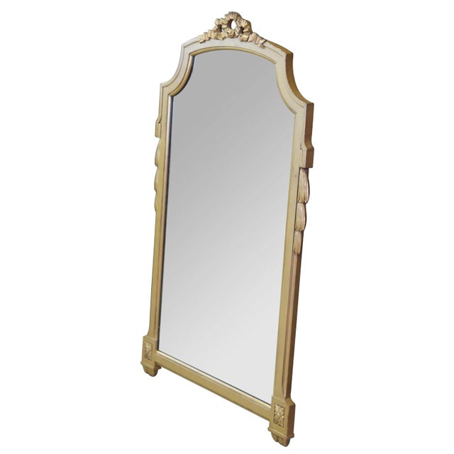 A beautiful mid 20th century neoclassical style wall hanging mirror. Attributed to Robert W. Irwin. Finished in gold with...