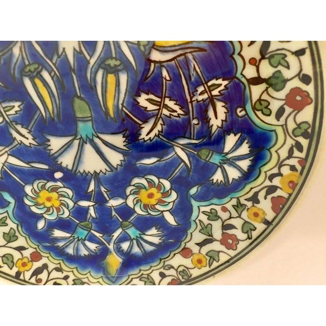 Vintage Polychrome hand painted and handcrafted ceramic wall decorative plate with polychrome floral design. This is an...