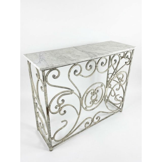 Elevate an entryway, hallway, or living area with this vintage French Provincial style console table. Built with a wrought...