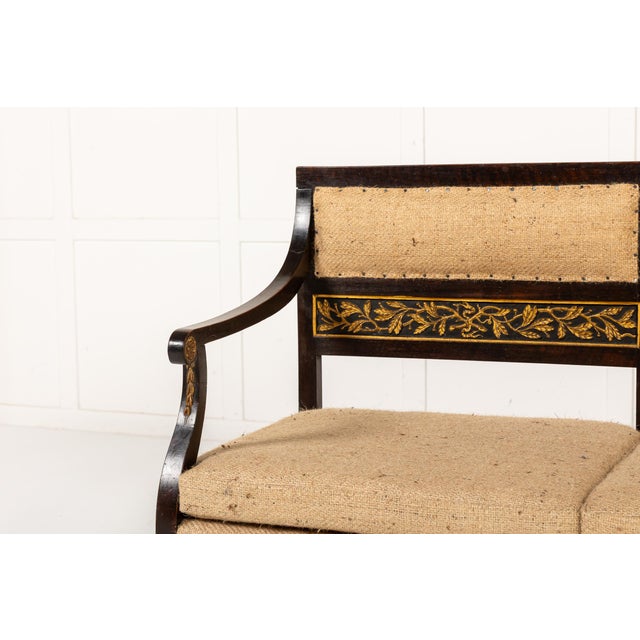 An Early 19th Century Italian Painted and Carved Gilt Settee. Designed to comfortably seat three people, this settee is...