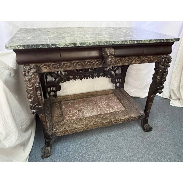 Fantastic Balinese style console table from the early 1900's. The piece is made of carved and pierced hardwoods with Asian...