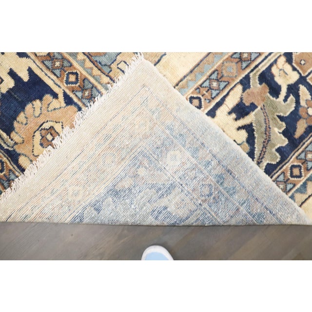 An early 20th Century Persian Mahal Rug featuring a large-scale all-over palmette pattern on a tan/cream ground 9'4'' x 12'