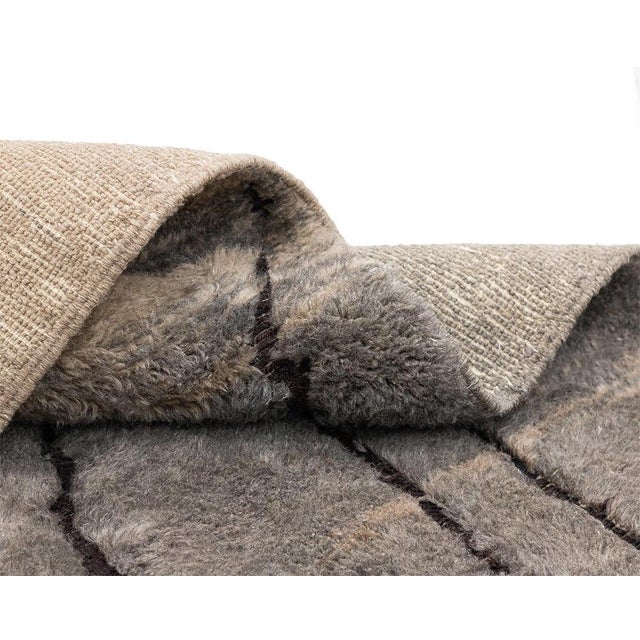 Luxurious hand-knotted wool rug, blending Light Taupe and Granite Gray tones with dynamic flat-woven abstract lines in...