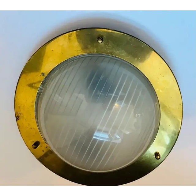 A 1960s nautical style golden brass ceiling fixture with a hallophane glass shade. Newly rewired.