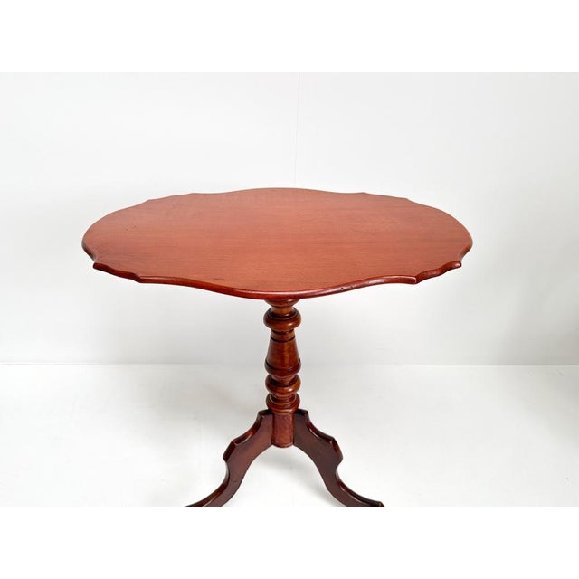 This lovely antique (19th century) mahogany tripod table is a charming piece that combines the timeless appeal of mahogany...