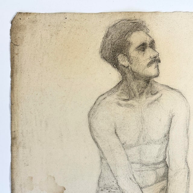A French academic life study of a seated male figure, executed in charcoal on woven cream toned paper. The sheet remains...