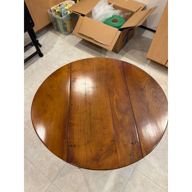 Small drop leaf table. Wood type is believed to be walnut. Slightly oval shape; when both leaves are extended the width is...