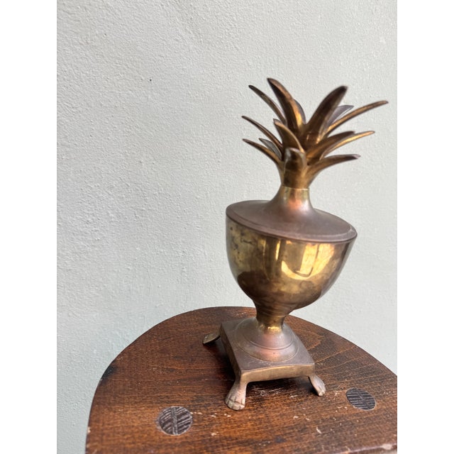 Someone's great-great-grandpa's sorbet cup during the day, portable chandelier at night. A solid brass pineapple urn with...