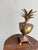 Someone's great-great-grandpa's sorbet cup during the day, portable chandelier at night. A solid brass pineapple urn with...