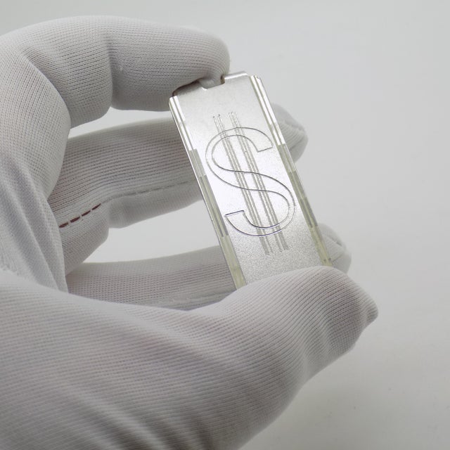 A sleek and functional vintage accessory, this Italian money clip features the iconic dollar symbol rendered in solid...