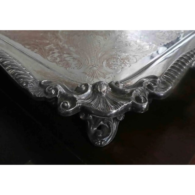 Early 20th century antique footed estate serving tray with handles. Classic ornate design, silver on copper.