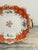 A 19th-century porcelain two-handled dish, with an orange border and gilt highlights, England circa 1860.