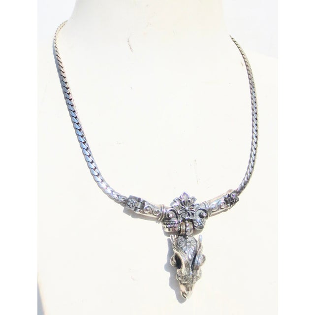 Zodiac Ram, Hallmarked Sterling to the back of the ram. Ornate Ram head in a setting ornamented by florets and scrolls, a...