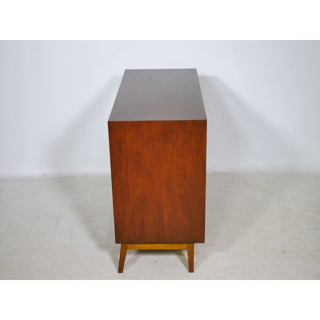 Vintage teak display sideboard, 1960s. The compact cabinet stands on tapered legs and features two sliding glass doors and...
