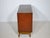 Vintage teak display sideboard, 1960s. The compact cabinet stands on tapered legs and features two sliding glass doors and...