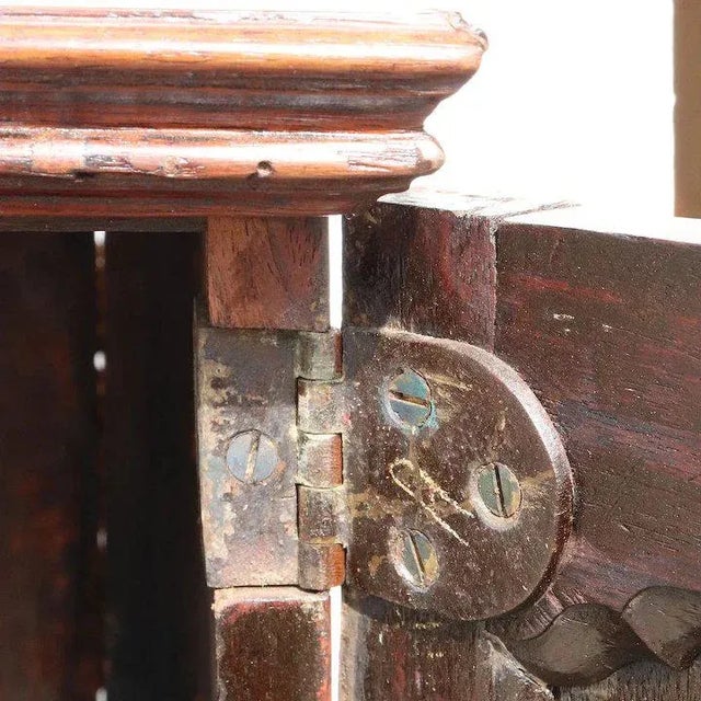 This very pretty, very useful, small antique cabinet was hand fashioned in an unusual form. It features a double door...