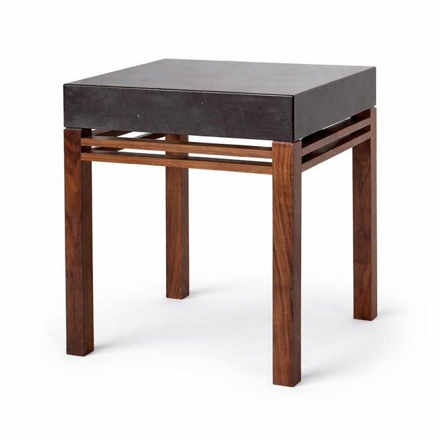 A striking mid century bedside table combining warm teak with a sleek dark acrylic top, creating a beautifully balanced...