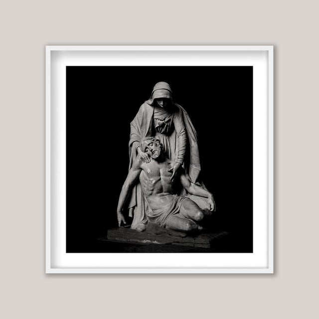 A poignant sepia-toned photograph captures a majestic and elegant statue of Jesus Christ, moments after being taken down...